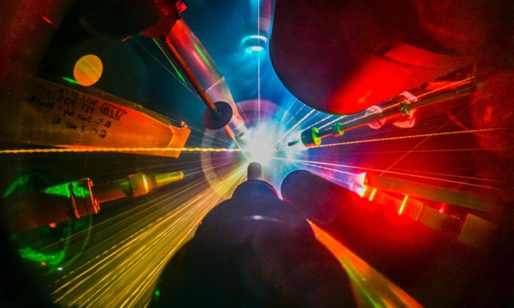Multiple lasers pointing and shooting at a target during a direct-drive inertial fusion experiment.
