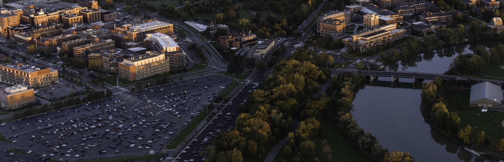 Aerial photo of University of Rochester's River Campus and Medical Center along with downtown Rochester, NY in in the evening